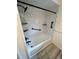 Bathroom with black fixtures and subway tile in shower over tub at 7211 Antigua Pl, Sarasota, FL 34231