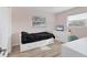 Bright bedroom with wood look floors, white furniture and two windows at 7211 Antigua Pl, Sarasota, FL 34231