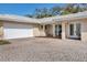 Close-up of a home showing the garage, main entry and brick paver driveway at 7211 Antigua Pl, Sarasota, FL 34231