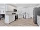 Modern kitchen boasts stainless steel appliances, white cabinetry, and sleek countertops at 7211 Antigua Pl, Sarasota, FL 34231