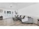 Cozy living room featuring a large bay window and comfortable gray sectional sofa at 7211 Antigua Pl, Sarasota, FL 34231