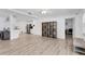 Open living area with views of kitchen and large decorative shelving unit at 7211 Antigua Pl, Sarasota, FL 34231