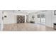 Bright open living space with neutral walls, decorative shelving, and outdoor access at 7211 Antigua Pl, Sarasota, FL 34231