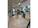 Sun-filled kitchen has island, modern appliances, white cabinets, and stone countertops at 728 41St St St, Sarasota, FL 34234