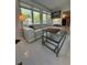 Bright living room with white tile floors, comfortable seating, and backyard views at 728 41St St St, Sarasota, FL 34234
