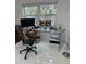 Bright office space with a modern glass desk, multiple monitors, and a comfortable ergonomic chair at 728 41St St St, Sarasota, FL 34234