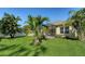 A spacious backyard is framed by lush landscaping and the screened-in lanai at 7424 Ridgelake Cir, Bradenton, FL 34203