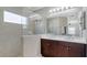 Modern bathroom with dual sinks, dark wood cabinetry, shower, and plenty of natural light at 7424 Ridgelake Cir, Bradenton, FL 34203