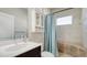 Bright bathroom features a shower/tub combo with tile surround, a modern vanity, and cabinet storage at 7424 Ridgelake Cir, Bradenton, FL 34203