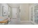 Bright foyer featuring neutral walls, tile flooring, a bench, and a clear view of the front door at 7424 Ridgelake Cir, Bradenton, FL 34203