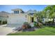 Charming home featuring a well-manicured lawn and a two-car garage, with inviting curb appeal at 7424 Ridgelake Cir, Bradenton, FL 34203