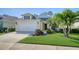 Attractive one-story home featuring a well-kept lawn and a two-car garage, perfect for suburban living at 7424 Ridgelake Cir, Bradenton, FL 34203