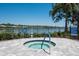Inviting community hot tub offers residents a relaxing space, set against a scenic lake backdrop at 7424 Ridgelake Cir, Bradenton, FL 34203