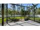 Bright lanai with tile floor features a screened enclosure and views of the backyard at 7424 Ridgelake Cir, Bradenton, FL 34203