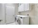The laundry room features a washer and dryer, overhead storage cabinets, and convenient access at 7424 Ridgelake Cir, Bradenton, FL 34203