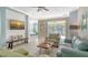Inviting living room featuring modern decor, tile floors, and a sliding glass door to the outdoor patio at 7424 Ridgelake Cir, Bradenton, FL 34203