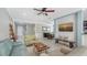 Comfortable living room with tile floors, neutral colors, and seamless transition to dining area at 7424 Ridgelake Cir, Bradenton, FL 34203