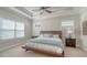 Bright main bedroom featuring tray ceilings, ceiling fan, and large windows for ample natural light at 7424 Ridgelake Cir, Bradenton, FL 34203