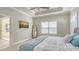 Spacious main bedroom with tray ceilings, ceiling fan, flat screen tv, and a large window at 7424 Ridgelake Cir, Bradenton, FL 34203