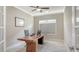 This bright office space is enhanced with a ceiling fan, window, and statement wood desk at 7424 Ridgelake Cir, Bradenton, FL 34203