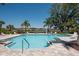 Sparkling community pool features a spacious deck, comfortable lounge chairs, and scenic lake views at 7424 Ridgelake Cir, Bradenton, FL 34203