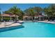 Community pool features ample seating, cabanas, and a clear blue pool offering resort-style relaxation at 7424 Ridgelake Cir, Bradenton, FL 34203