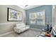 Comfortable sitting area with modern white furniture, natural light, and artistic accents at 7424 Ridgelake Cir, Bradenton, FL 34203