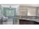 Bright sitting area features granite counters, and a view of the adjacent living area at 7424 Ridgelake Cir, Bradenton, FL 34203
