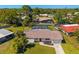 Aerial view of a single-Gathering home with a screened pool and lush landscaping at 7460 Mariana Dr, Sarasota, FL 34231