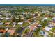 An aerial view of a neighborhood showcasing the home, nearby houses, streets, and mature trees at 7460 Mariana Dr, Sarasota, FL 34231