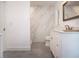 Modern bathroom featuring gray tile flooring, a marble tiled shower, and a white vanity at 800 Everest Rd, Venice, FL 34293