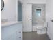 Modern bathroom with marble countertop, gray tile, and tub-shower combo at 800 Everest Rd, Venice, FL 34293