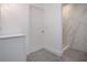 Modern bathroom with gray tile flooring and marble-tiled shower with pebble floor at 800 Everest Rd, Venice, FL 34293