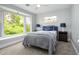 Well-lit bedroom boasting large bay window, ceiling fan, and neutral color scheme at 800 Everest Rd, Venice, FL 34293