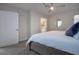 Bright bedroom featuring a ceiling fan, a round mirror, and an ensuite bathroom at 800 Everest Rd, Venice, FL 34293