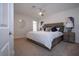 Serene main bedroom with a ceiling fan, neutral-toned walls, carpet flooring, and a decorative mirror at 800 Everest Rd, Venice, FL 34293
