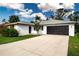 Well-maintained single-story home featuring a two-car garage and lush landscaping at 800 Everest Rd, Venice, FL 34293