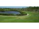 Scenic golf course view featuring a pond and golf cart on the path at 800 Everest Rd, Venice, FL 34293