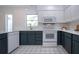 Bright kitchen with ample cabinet space, stainless steel appliances and tile flooring at 800 Everest Rd, Venice, FL 34293