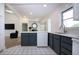Kitchen area featuring an island with bar seating, contrasting cabinets, and an open view to the living space at 800 Everest Rd, Venice, FL 34293