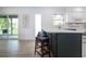 Kitchen featuring a breakfast bar, modern countertops, stainless steel appliances, and backyard views at 800 Everest Rd, Venice, FL 34293