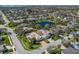 Aerial view showcases a home on a landscaped lot near a pond, nestled within a tranquil neighborhood at 8861 17Th Avenue Nw Cir, Bradenton, FL 34209