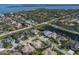 Wide aerial shot of a neighborhood featuring waterfront homes, lush landscaping, and picturesque canals and waterways at 8861 17Th Avenue Nw Cir, Bradenton, FL 34209