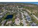 Aerial view showcases home nestled in a scenic neighborhood with ponds and lush surroundings at 8861 17Th Avenue Nw Cir, Bradenton, FL 34209