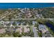 Gorgeous aerial view of a home in a waterfront community with lush landscaping and beautiful blue water in the background at 8861 17Th Avenue Nw Cir, Bradenton, FL 34209