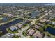 Expansive aerial view of a vibrant community featuring lush landscaping, serene lakes, and beautiful homes at 8861 17Th Avenue Nw Cir, Bradenton, FL 34209