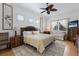 Bright bedroom with a ceiling fan, natural light, and a seating area at 8861 17Th Avenue Nw Cir, Bradenton, FL 34209