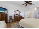 Bedroom with hardwood floors, a ceiling fan, and a cozy seating area at 8861 17Th Avenue Nw Cir, Bradenton, FL 34209