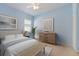 Serene bedroom with soft blue walls, natural light, and stylish furnishings creates a calming retreat at 8861 17Th Avenue Nw Cir, Bradenton, FL 34209