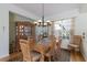 Inviting dining room with hardwood floors, a china cabinet, chandelier lighting, and natural light from the window at 8861 17Th Avenue Nw Cir, Bradenton, FL 34209